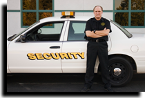 Security officer standing next to car